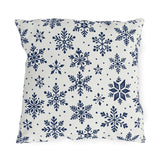 Snowflake outdoor pillow with navy blue snowflakes and small dots on crisp off-white