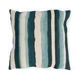 Teal and cream painted stripes on an outdoor pillow