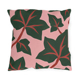 Modern outdoor pillow with oversized dark green ivy leaves and red veins on blush pink