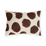 Modern polka dot outdoor lumbar pillow with large hand painted chocolate brown dots on cream