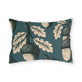 Cream and black block print acorns and oak leaves on a deep teal outdoor lumbar pillow