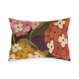 Mid-century hydrangea outdoor lumbar pillow with oversized pink, orange and mustard hydrangeas on plum