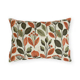 Rust leaves, olive seed pods and small blooms block printed on a cream outdoor lumbar pillow
