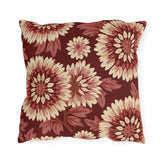 Cream and blush chrysanthemums on a deep oxblood outdoor pillow