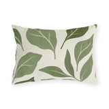 Sage green outdoor lumbar pillow with large abstract sage and olive leaves on off-white
