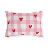 Light pink gingham outdoor lumbar pillow with small red hearts