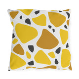 Yellow terrazzo outdoor pillow with large yellow and ochre stones and charcoal chips on white