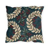 Cream laurel branches and red berries on a deep teal outdoor pillow