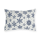 Snowflake outdoor lumbar pillow with navy blue snowflakes and small dots on crisp off-white