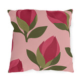 Floral outdoor pillow with cut-paper raspberry pink flower buds and olive green leaves on blush