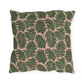 Dark green pine sprigs on blush peach outdoor pillow
