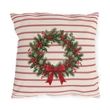 Christmas wreath outdoor pillow with a pine and berry wreath and red bow on cream with cranberry pinstripes