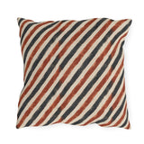 Diagonal rust and charcoal block-printed stripes on cream outdoor pillow