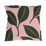 Modern outdoor pillow with oversized forest green leaves and red midribs on blush pink