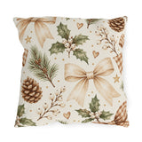 Christmas outdoor pillow with watercolor pinecones, holly with white berries, pine sprigs and ribbon bows on cream