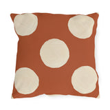 Modern polka dot outdoor pillow with large hand painted cream dots on terracotta orange