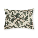 Ivory and sage ribbon bows on cedar sprigs with white berries on a cream outdoor lumbar pillow