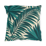 Tropical outdoor pillow with large overlapping teal palm fronds on cream