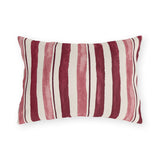 Cranberry and rose painted stripes on a cream outdoor lumbar pillow
