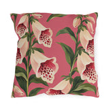Floral outdoor pillow with painted cream foxgloves speckled in crimson and green leaves on rose pink