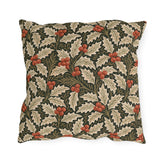 Ivory and olive holly leaves with coral berries on a deep green outdoor pillow