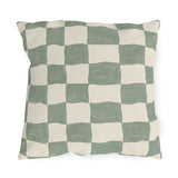 Modern outdoor pillow with a hand-painted sage green and cream checkerboard
