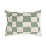 Modern outdoor lumbar pillow with a hand-painted sage green and cream checkerboard