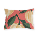 Fall outdoor lumbar pillow with cream and golden Chinese lantern pods and dark green leaves on coral pink