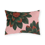Floral outdoor lumbar pillow with oversized dark green dahlias tipped in rust red on blush pink