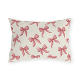 Rose pink engraved ribbon bows scattered on cream outdoor lumbar pillow