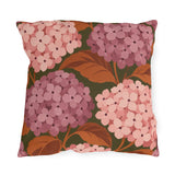 Pink hydrangea outdoor pillow with blush and rose hydrangea blooms and rust leaves on olive green