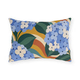 Groovy hydrangea outdoor lumbar pillow with cornflower blue hydrangeas over retro orange, mustard and teal waves