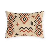 Boho mudcloth outdoor lumbar pillow with terracotta and black diamonds, zigzags and crosses on sand