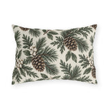 Pine branches, cedar sprigs, pinecones and white berries on a cream outdoor lumbar pillow