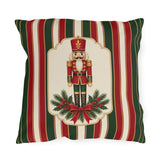 Vintage Christmas nutcracker outdoor pillow with a framed nutcracker soldier, pine and a red bow on red, green and cream stripes