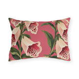 Floral outdoor lumbar pillow with painted cream foxgloves speckled in crimson and green leaves on rose pink