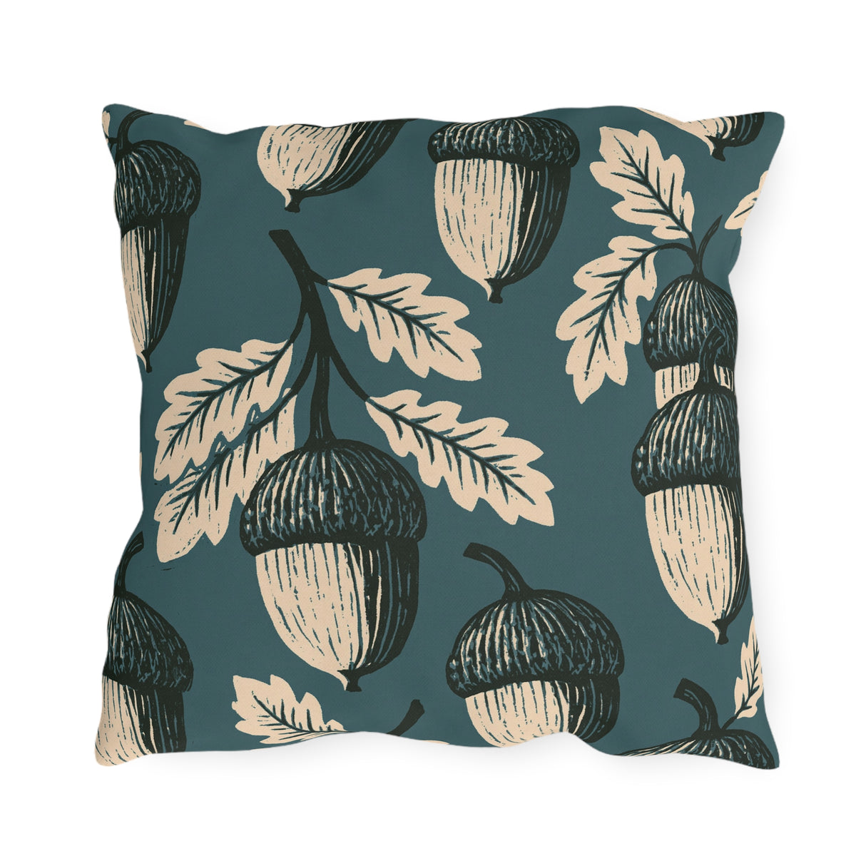 Cream and black block print acorns and oak leaves on a deep teal outdoor pillow