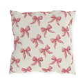 Rose pink engraved ribbon bows scattered on cream outdoor pillow