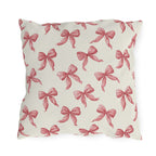 Rose pink engraved ribbon bows scattered on cream outdoor pillow