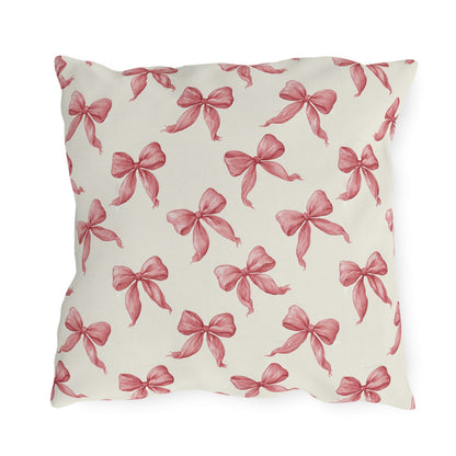 Rose pink engraved ribbon bows scattered on cream outdoor pillow