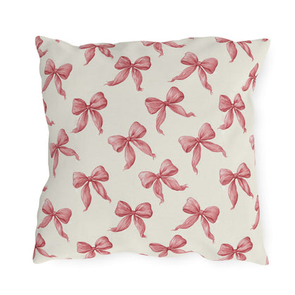 Rose pink engraved ribbon bows scattered on cream outdoor pillow