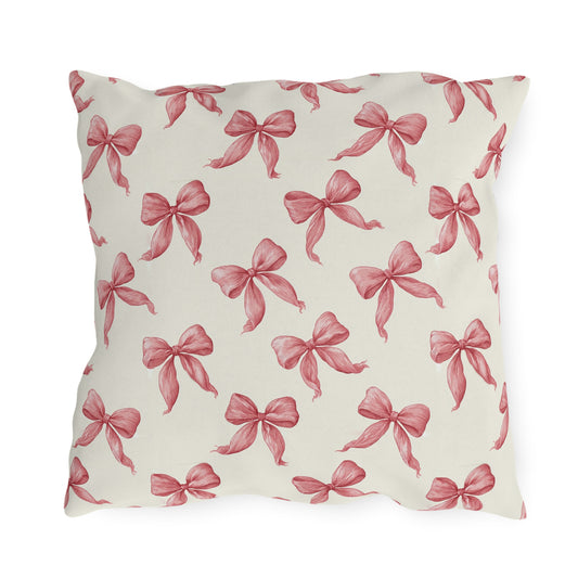 Rose pink engraved ribbon bows scattered on cream outdoor pillow