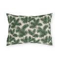 Deep green pine and fir branches on cream outdoor lumbar pillow