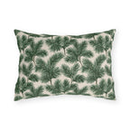 Deep green pine and fir branches on cream outdoor lumbar pillow