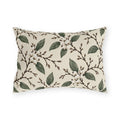 White snowberries on brown branches with green leaves on a cream outdoor lumbar pillow