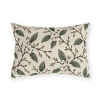 White snowberries on brown branches with green leaves on a cream outdoor lumbar pillow