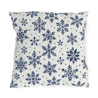 Snowflake outdoor pillow with navy blue snowflakes and small dots on crisp off-white