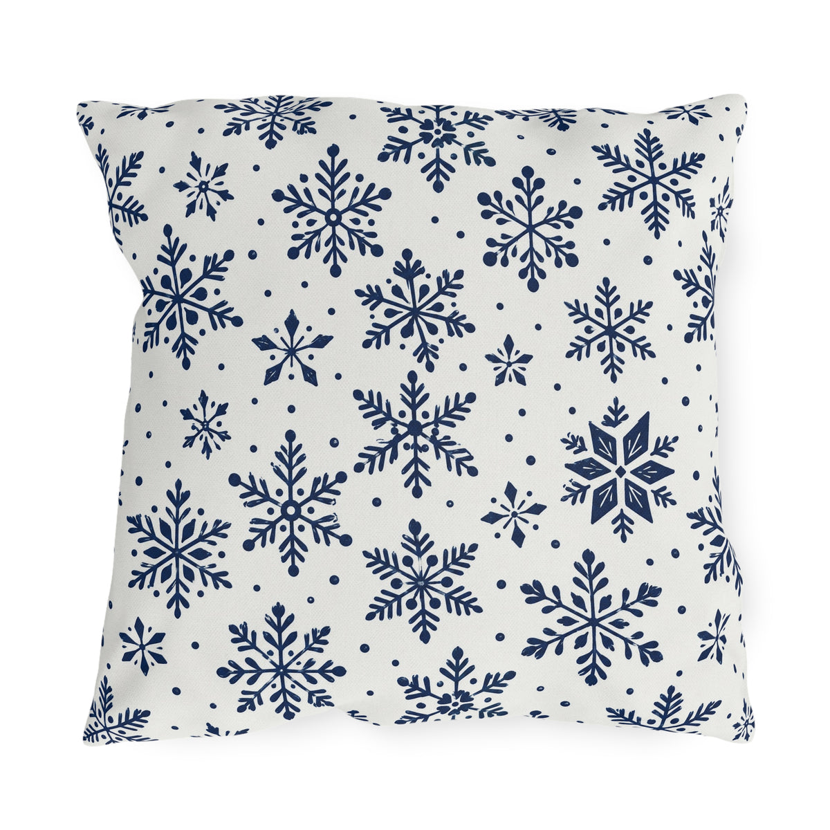 Snowflake outdoor pillow with navy blue snowflakes and small dots on crisp off-white