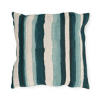 Teal and cream painted stripes on an outdoor pillow