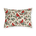 Christmas cardinal outdoor lumbar pillow with red cardinals, snowy pine sprigs, pinecones and red berries on soft cream